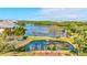 Scenic pond view with mature landscaping and benches for relaxation at 10037 62Nd N Ter # 23, St Petersburg, FL 33708
