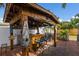 Outdoor bar area with bamboo construction, bar seating, and tropical decor in the backyard at 1004 68Th Nw St, Bradenton, FL 34209
