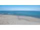 Serene beach with calm, clear blue water and soft white sand on a sunny day at 1004 68Th Nw St, Bradenton, FL 34209