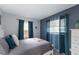 Well-lit bedroom features a queen bed and curtains, offering a peaceful retreat at 1004 68Th Nw St, Bradenton, FL 34209