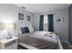 Bright bedroom with light gray walls, a queen bed, and accent pillows at 1004 68Th Nw St, Bradenton, FL 34209