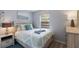 Cozy bedroom with a patterned comforter, complemented by light-toned furniture and decor at 1004 68Th Nw St, Bradenton, FL 34209