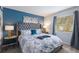 Cozy bedroom with stylish decor, blue accent wall and plenty of natural light at 1004 68Th Nw St, Bradenton, FL 34209