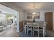 An inviting dining room features a wooden table, chairs, stylish rug, and elegant pendant lighting at 1004 68Th Nw St, Bradenton, FL 34209
