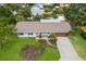 Charming single-story home with a well-manicured lawn and beautiful tropical landscaping at 1004 68Th Nw St, Bradenton, FL 34209