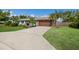 Exterior features include a long driveway, stone accents, and lush tropical landscaping at 1004 68Th Nw St, Bradenton, FL 34209