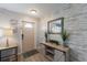 Foyer with modern accents, decorative console table and a plank accent wall at 1004 68Th Nw St, Bradenton, FL 34209