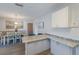 Bright kitchen featuring granite countertops, blue backsplash, and dining area with pendant lighting at 1004 68Th Nw St, Bradenton, FL 34209
