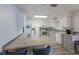 Bright kitchen with white cabinets, stainless steel appliances, and bar seating with granite countertops at 1004 68Th Nw St, Bradenton, FL 34209