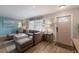 Bright living room with gray sectional, plank floors, and large windows providing ample natural light at 1004 68Th Nw St, Bradenton, FL 34209