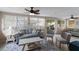 Cozy living room filled with natural light, featuring comfortable seating, ceiling fans, and stylish decor at 1004 68Th Nw St, Bradenton, FL 34209
