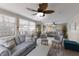 Bright living room with large windows, comfortable seating, ceiling fans, and access to the outdoors at 1004 68Th Nw St, Bradenton, FL 34209