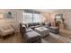 Inviting living room featuring a large sectional couch, stylish decor, and wood-look flooring at 1004 68Th Nw St, Bradenton, FL 34209