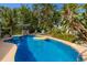 Beautiful in-ground pool with sunny patio and lush tropical landscape at 1004 68Th Nw St, Bradenton, FL 34209