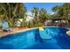 Backyard pool surrounded by lush landscape provides a perfect place to relax and unwind at 1004 68Th Nw St, Bradenton, FL 34209