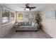 Bright sun room featuring comfortable seating, natural light, and tropical-themed decor at 1004 68Th Nw St, Bradenton, FL 34209