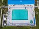 Aerial view of the community pool and spa, surrounded by lounge chairs at 10315 Cortez W Rd # 24-2, Bradenton, FL 34210