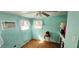 Cozy bedroom with bright teal walls and a ceiling fan at 10315 Cortez W Rd # 24-2, Bradenton, FL 34210