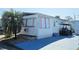 Inviting single-story home featuring awnings for shade and a designated parking area with convenient golf cart parking at 10315 Cortez W Rd # 24-2, Bradenton, FL 34210
