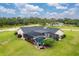 Aerial view of the property showcasing the pool, screened lanai, and landscaped backyard at 1071 Owl Dr, Englewood, FL 34223