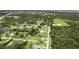 Aerial view of a home nestled in a lush, green neighborhood with mature trees at 1071 Owl Dr, Englewood, FL 34223