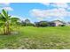 Expansive backyard with lush greenery and a screened-in lanai for outdoor enjoyment at 1071 Owl Dr, Englewood, FL 34223