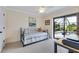 Comfortable bedroom with pool view, ceiling fan and adjacent desk area at 1071 Owl Dr, Englewood, FL 34223