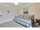 Comfortable bedroom with a coastal painting, ceiling fan, and neutral decor at 1071 Owl Dr, Englewood, FL 34223