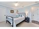 Cozy bedroom with a metal bed frame, ceiling fan and calming coastal decor at 1071 Owl Dr, Englewood, FL 34223