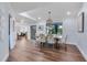 Elegant dining room with wood floors, stylish lighting, and views to the pool at 1071 Owl Dr, Englewood, FL 34223