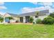 Attractive home exterior featuring well-manicured landscaping and decorative potted plants at 1071 Owl Dr, Englewood, FL 34223