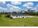 Exterior view of the house, highlighting the screened-in pool and surrounding landscape at 1071 Owl Dr, Englewood, FL 34223