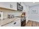 Updated kitchen with granite countertops, modern appliances, and plenty of cabinet space at 1071 Owl Dr, Englewood, FL 34223