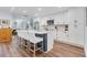 Spacious kitchen with white cabinets, large island, and stainless steel appliances at 1071 Owl Dr, Englewood, FL 34223