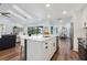 Open kitchen with island overlooking the living and dining areas, with great natural light at 1071 Owl Dr, Englewood, FL 34223