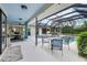 Covered lanai with a pool, dining and lounge areas, and multiple access points to the house at 1071 Owl Dr, Englewood, FL 34223