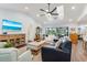 Bright living room with vaulted ceilings and open floor plan leading to the outdoor pool area at 1071 Owl Dr, Englewood, FL 34223