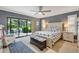 Cozy main bedroom featuring sliding glass doors to the screened pool at 1071 Owl Dr, Englewood, FL 34223