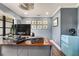 Stylish office space with a wood desk, gallery wall, and a retro mini-fridge at 1071 Owl Dr, Englewood, FL 34223
