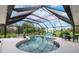 Enclosed pool area featuring a unique kidney shape, lounge chairs, and a covered patio at 1071 Owl Dr, Englewood, FL 34223