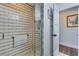 Walk-in shower with neutral tile, glass door, and grab bar for accessibility at 1071 Owl Dr, Englewood, FL 34223