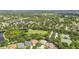 Aerial view of a community with green space, multiple ponds, and mature landscaping at 11009 Wildcat Dr, Riverview, FL 33579