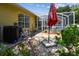 Exterior view shows backyard of home with stone walkway leading to screened in pool at 11009 Wildcat Dr, Riverview, FL 33579
