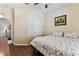 Comfortable bedroom featuring a ceiling fan, hardwood floors, a cozy bed, and a window at 11009 Wildcat Dr, Riverview, FL 33579