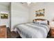 Cozy bedroom with wood flooring, a decorative headboard, and a comfortable bed at 11009 Wildcat Dr, Riverview, FL 33579