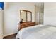 Relaxing bedroom with neutral walls, a comfortable bed and a mirrored dresser at 11009 Wildcat Dr, Riverview, FL 33579