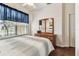 Bright bedroom featuring wood floors, a large window and a light color palette at 11009 Wildcat Dr, Riverview, FL 33579