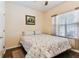 Cozy bedroom featuring a comfortable queen-size bed, hardwood flooring, and a window for natural light at 11009 Wildcat Dr, Riverview, FL 33579