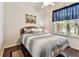 Bedroom featuring a comfortable bed, hardwood flooring, a ceiling fan, and a window with a view at 11009 Wildcat Dr, Riverview, FL 33579