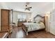 Comfortable bedroom featuring hardwood floors and elegant decor, including a large bed and wardrobe at 11009 Wildcat Dr, Riverview, FL 33579